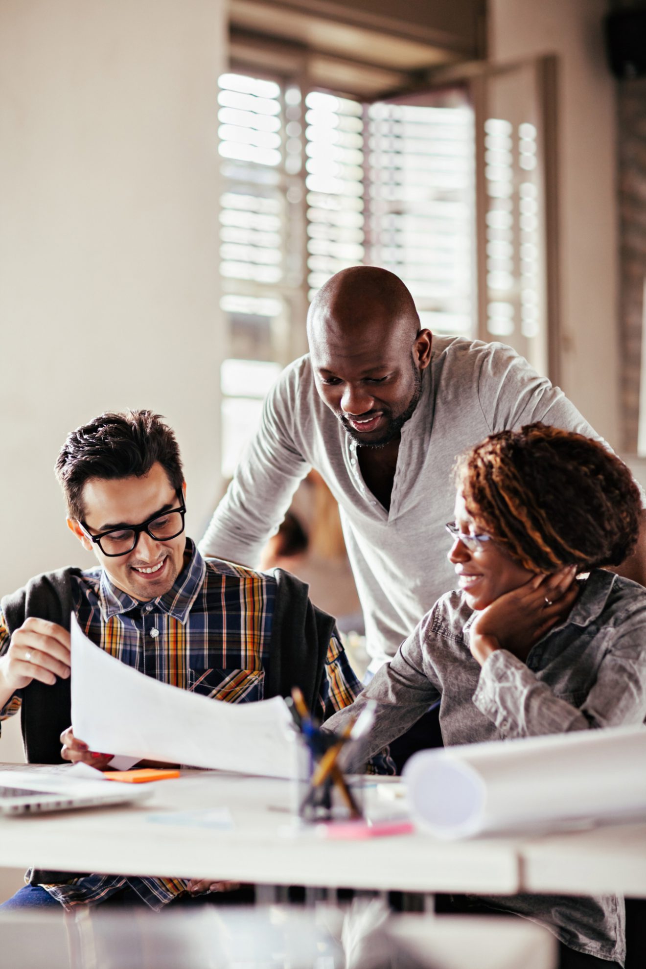 Group of people in bright room working together