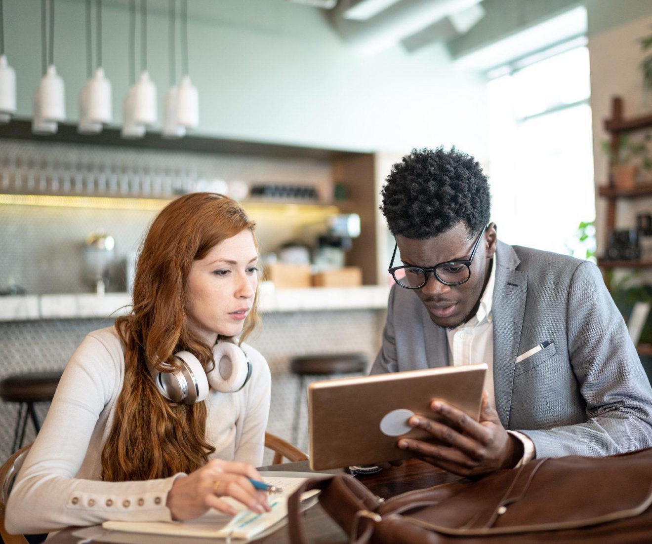 Two people referencing a tablet