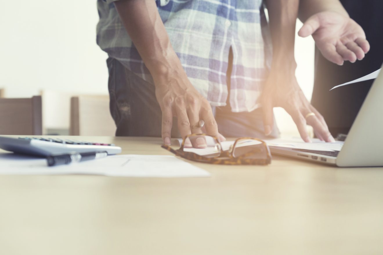 men working with calculator, business document and laptop computer notebook
