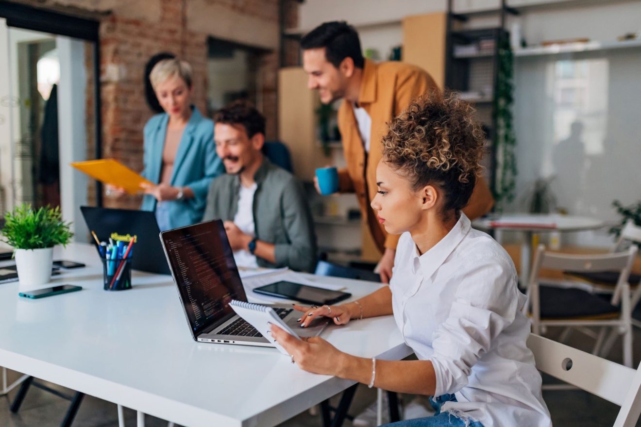 A group of people collaborate and cowork in a shared space