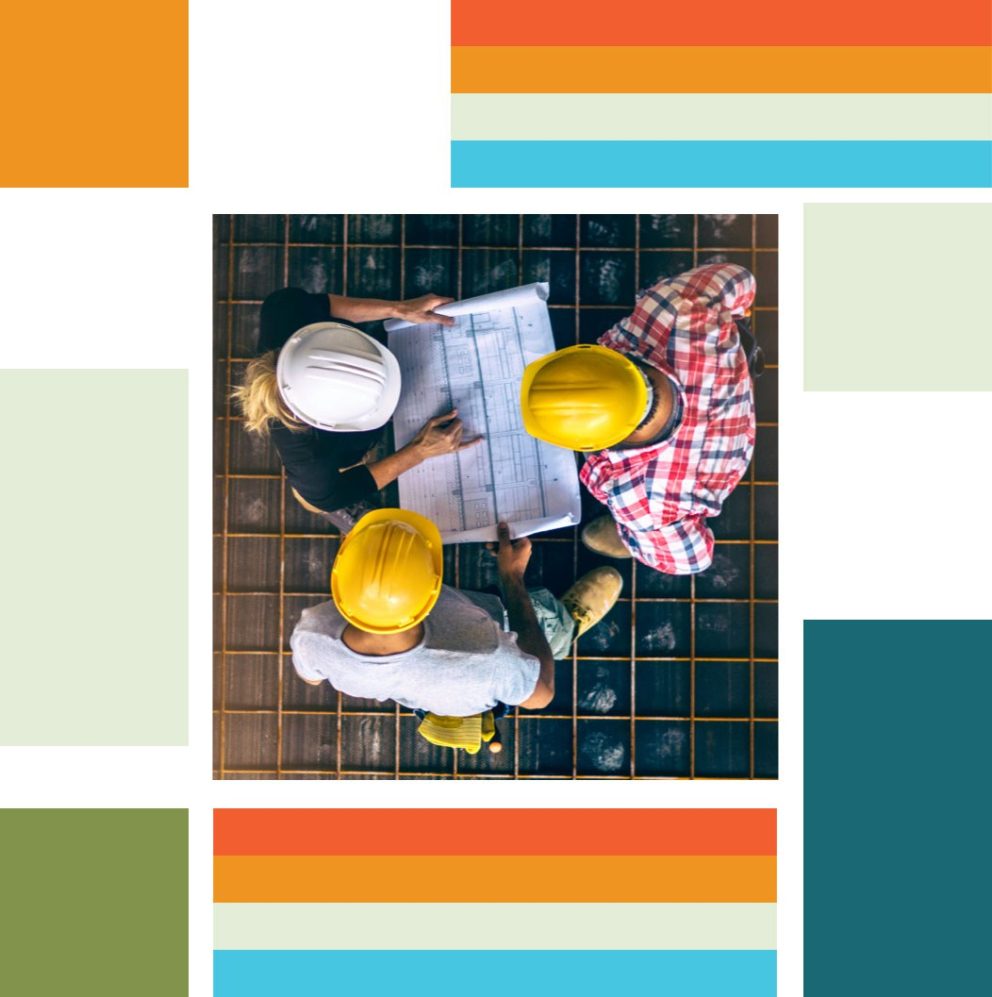 Three people in hardhats collaborating over a blueprint