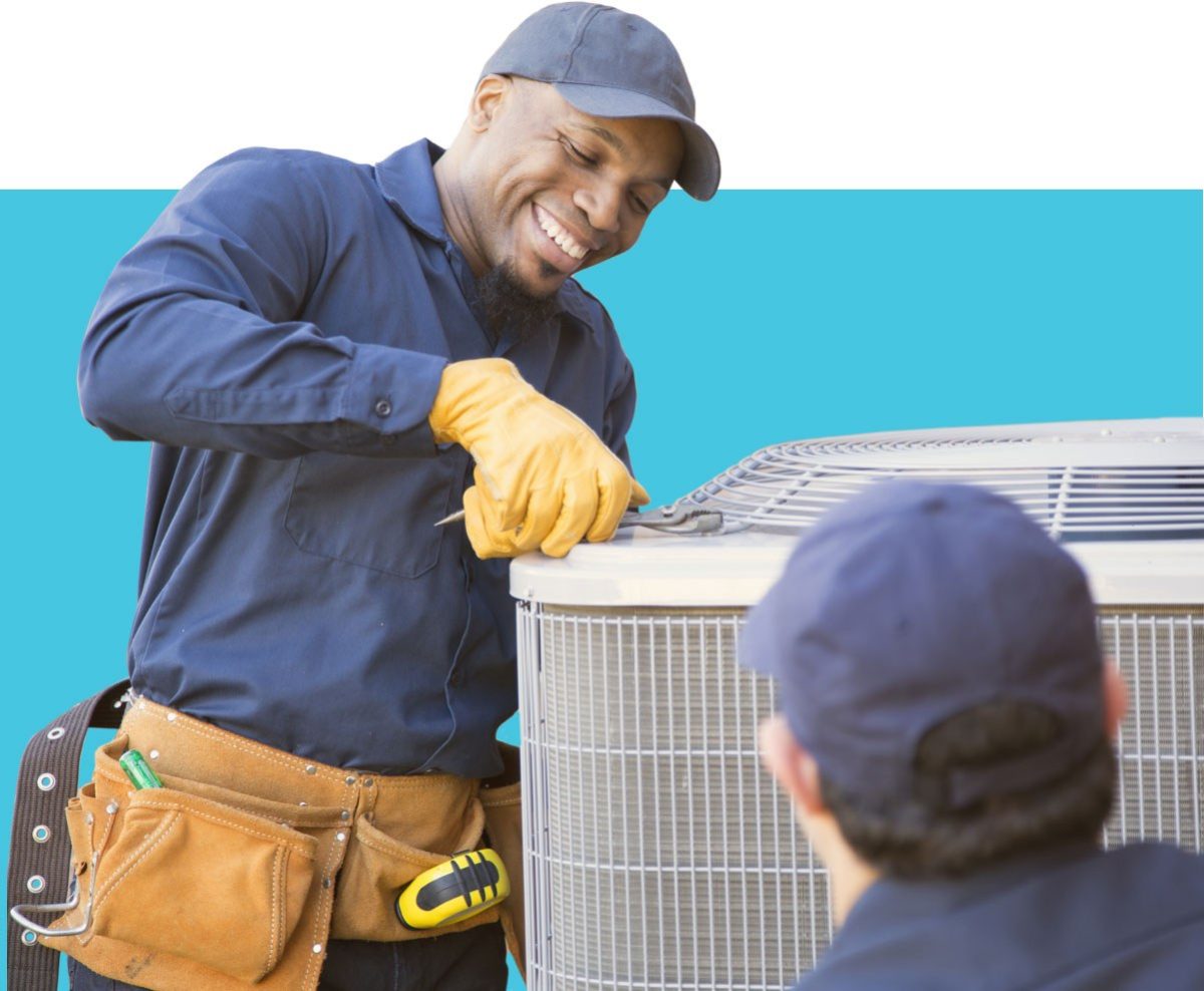 Handyman fixing machine as other man watches