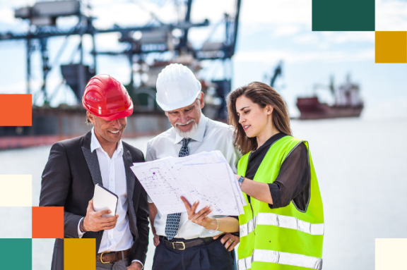 woman in reflective vest showing blueprints to two men in hard hats and business attire